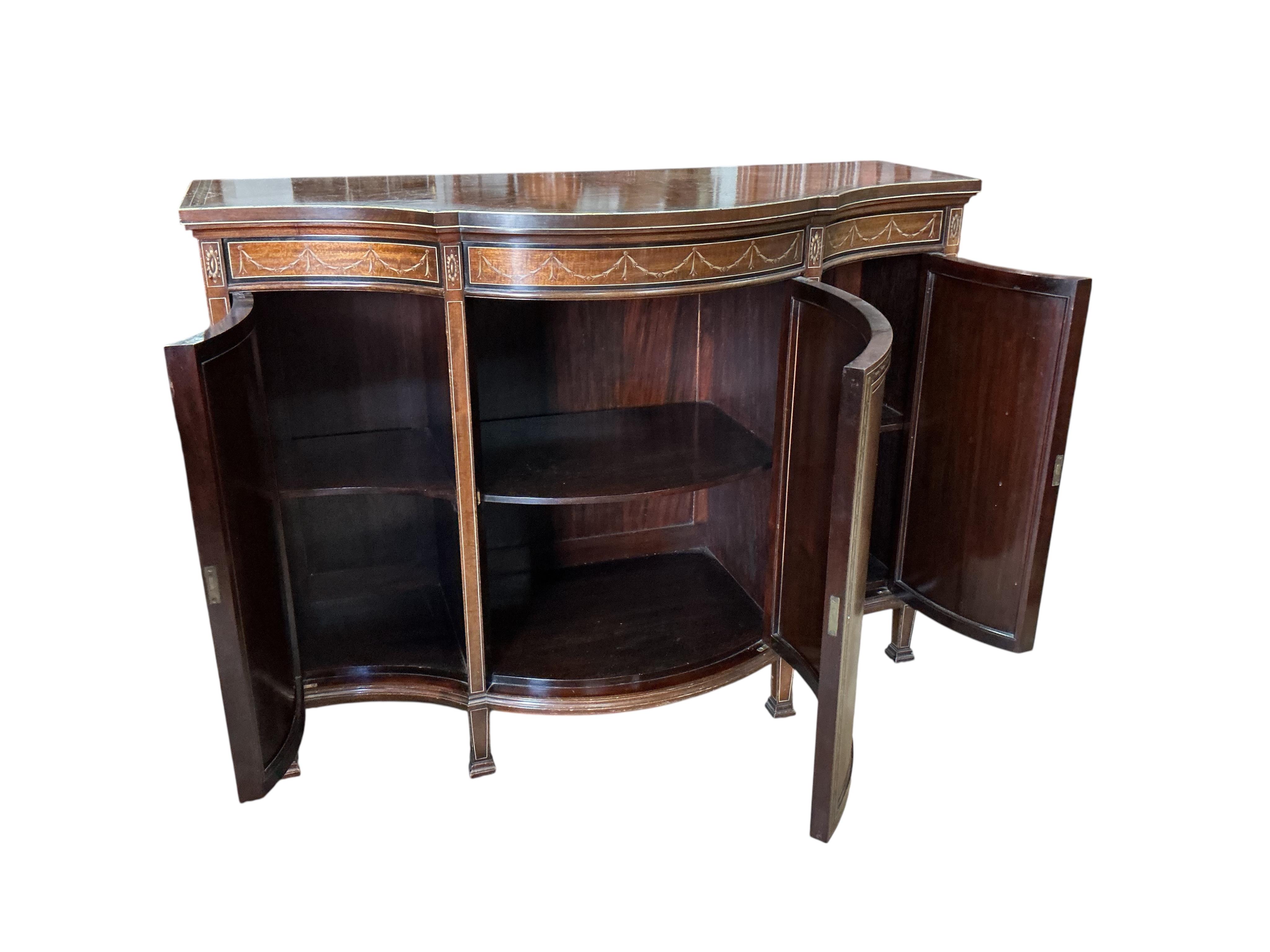 An Edwardian Sheraton Revival painted mahogany bowfront side cabinet